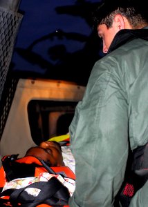 US Navy 100119-N-5244H-036 A Haitian woman with life-threatening injuries is medically evacuated to USS Bataan (LHD 5)