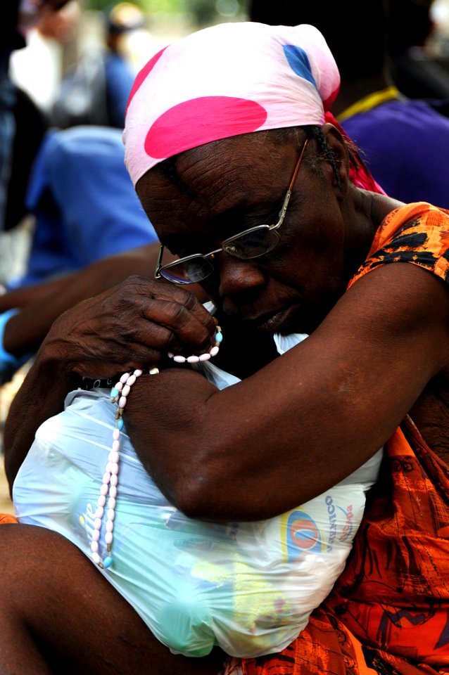 US Navy 100120-N-6247V-082 A Haitian woman clutches her rosary beads as an injured family member awaits treatment at the Killick Haitian Coast Guard Clinic