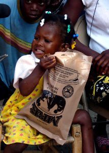 US Navy 100120-N-4971L-086 A Haitian girl enjoys her meal-ready-to-eat that U.S. service members distributed to Haitian citizens who live in the village of Birey