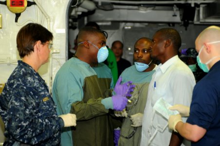 US Navy 100119-N-1831S-062 A Haitian man speaks with the medical staff aboard the multi-purpose amphibious assault ship USS Bataan (LHD 5) about his mother's condition photo