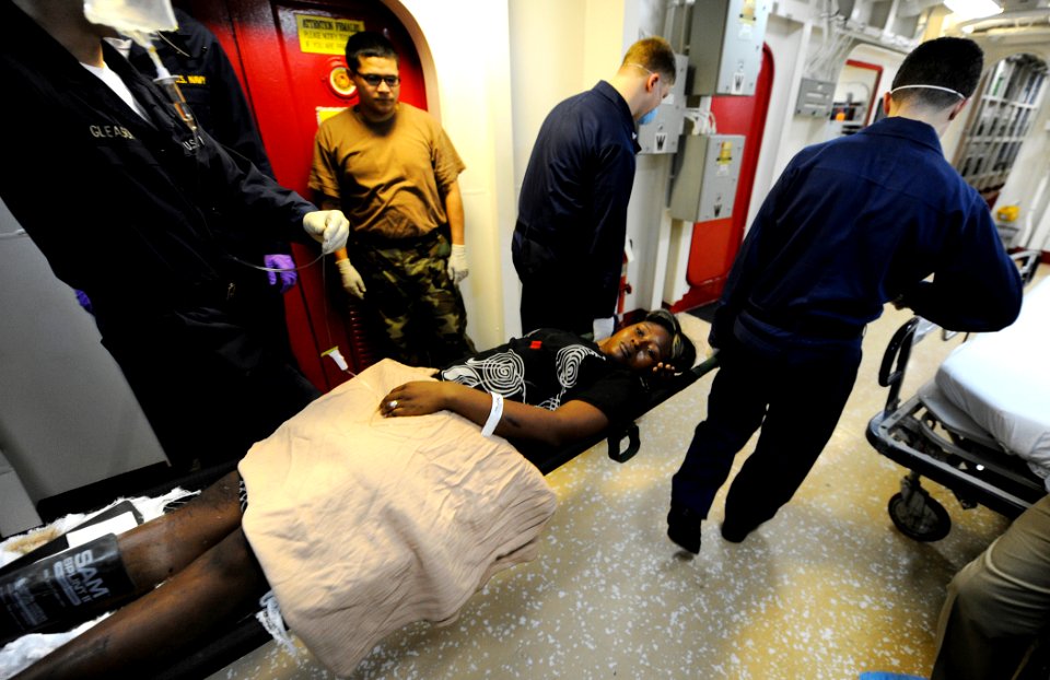 US Navy 100120-N-5345W-050 Stretcher bearers aboard USS Bataan (LHD 5) transfer an injured Haitian woman from main triage to the intensive care unit