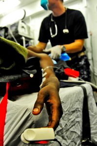 US Navy 100119-N-6006S-037 Medical staff aboard the Nimitz-class aircraft carrier USS Carl Vinson (CVN 70) monitor the vital signs of a Haitian boy injured in an earthquake