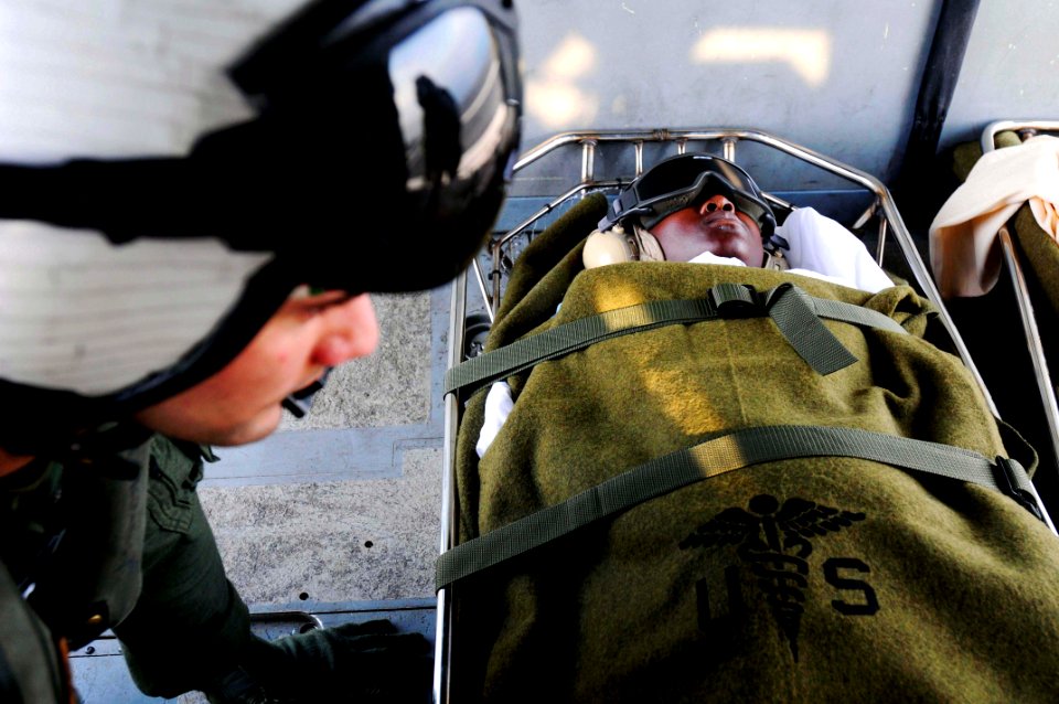 US Navy 100120-N-4378P-054 An air crewman secures patients to the floor of an MH-60s Sea Hawk helicopter