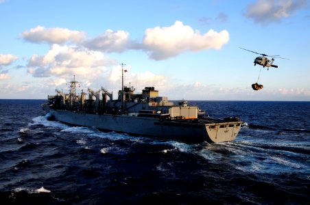 US Navy 100119-N-6604E-034 An SH-60F Sea Hawk helicopter assigned to the Nightdippers of Helicopter Anti-submarine Squadron (HS) 5 transports pallets of supplies from the Military Sealift Command fast combat support ship USNS S