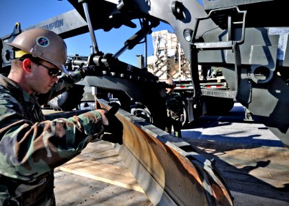 US Navy 100119-N-6889J-046 Seabees assigned to Naval Mobile Construction Battalion (NMCB) 7 prepare civil engineer support equipment for shipment to Haiti photo