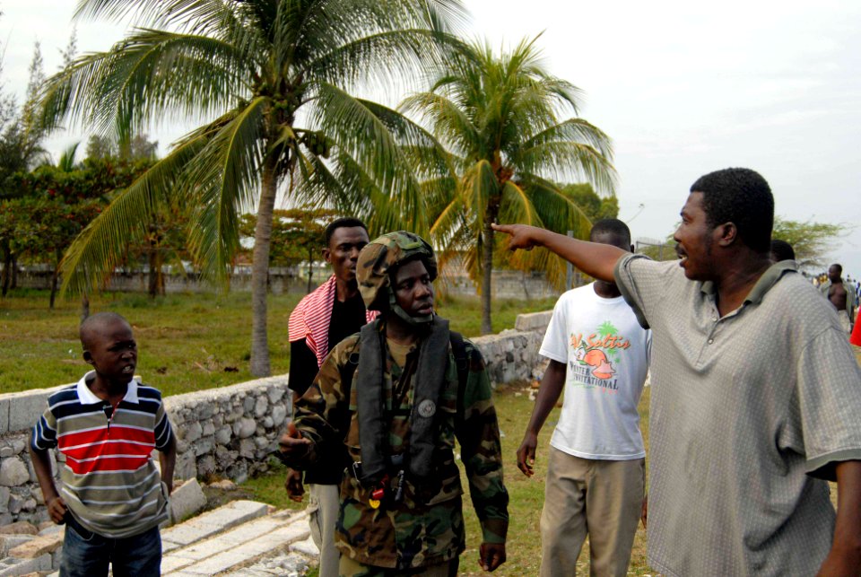 US Navy 100119-N-7653W-067 Haitian native Boatswain's Mate Seamen Dominique Pierre translates between service members and Haitian citizens