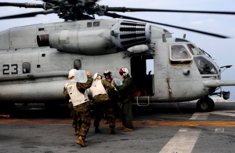 US Navy 100119-N-7508R-044 Marines load water onto a CH-53E Super Stallion helicopter aboard USS Bataan (LHD 5) photo