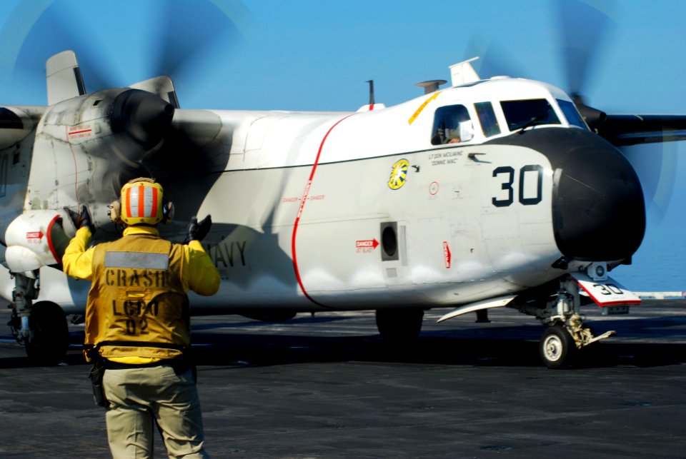 US Navy 100120-N-3589B-023 A Sailor directs a C-2A greyhound assigned to the Providers of Carrier Logistics Support Squadron (VRC) 30 aboard the aircraft carrier USS Nimitz (CVN 68)