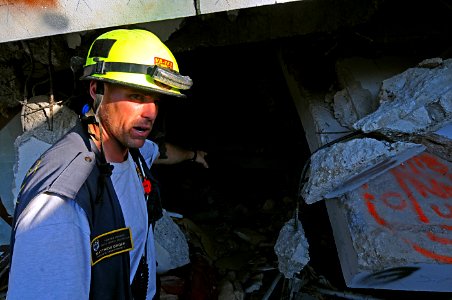 US Navy 100121-N-4275C-038 Matthew Groff, from the Fairfax County Urban Search and Rescue Team, surveys damage at Port-au-Prince's Hotel Montana