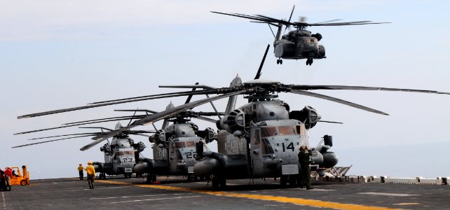 US Navy 100119-N-7508R-017 CH-53E Super Stallion helicopters assigned to Marine Heavy Helicopter Squadron (HMM) 461 conduct pre-flight checks prior to take-off aboard the multi-purpose amphibious assault ship USS Bataan (LHD 5) photo