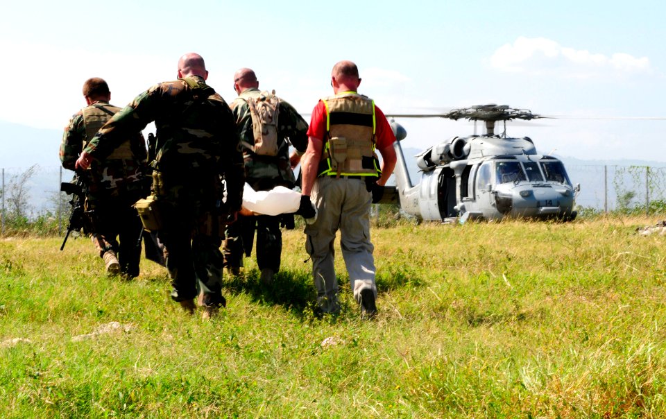 US Navy 100122-N-4378P-216 An earthquake victim is transported from the temporary triage facility, Terminal Varreux, to an MH-60S Sea Hawk helicopter