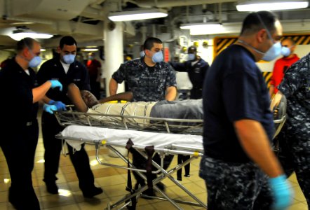 US Navy 100121-N-4774B-068 A medical response team aboard the Nimitz-class aircraft carrier USS Carl Vinson (CVN 70) transports an injured Haitian woman to an operating room