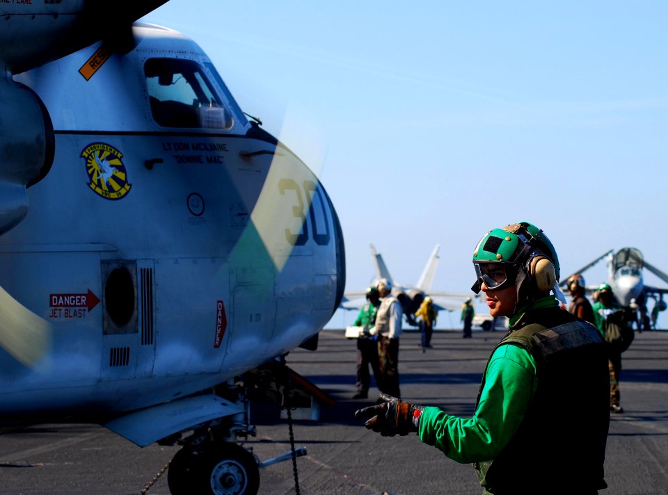 US Navy 100120-N-3589B-085 Aviation Machinist's Mate 3rd Class Oliver Vilchis performs a pre-flight safety check on a C-2A Greyhound assigned to the Providers of Carrier Logistics Support Squadron (VRC) 30 aboard the aircraft c