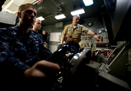US Navy 100120-N-7090S-012 Sonar Technician (Submarine) 1st Class Darrel Malone instructs students on basic functions of a submarine using one of four high-risk trainers at the Basic Enlisted Submarine School at Naval Submarine photo