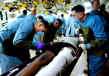 US Navy 100120-N-5345W-013 Medical personnel aboard USS Bataan (LHD 5) administer care to an injured Haitian man in the ship's medical triage