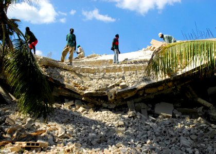 US Navy 100122-N-5244H-150 Residents of Leogane, Haiti, begin to clear the rubble left after an earthquake damaged their community photo