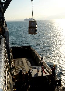 US Navy 100122-N-6676S-001 A pallet of humanitarian aid is craned from USS Gunston Hall (LSD 44) onto a landing craft unit off the coast of Killick