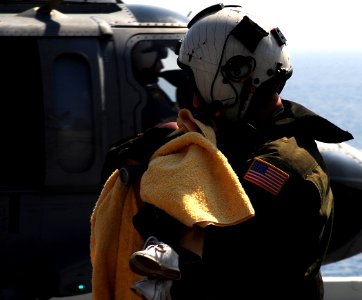 US Navy 100120-N-7508R-014 An air crewman carries a Haitian child to the flight deck triage area aboard USS Bataan (LHD 5)