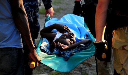US Navy 100123-N-4774B-866 Sailors assigned to the guided-missile Cruiser USS Normandy (CG 60) transport a Haitian girl for a medical evacuation