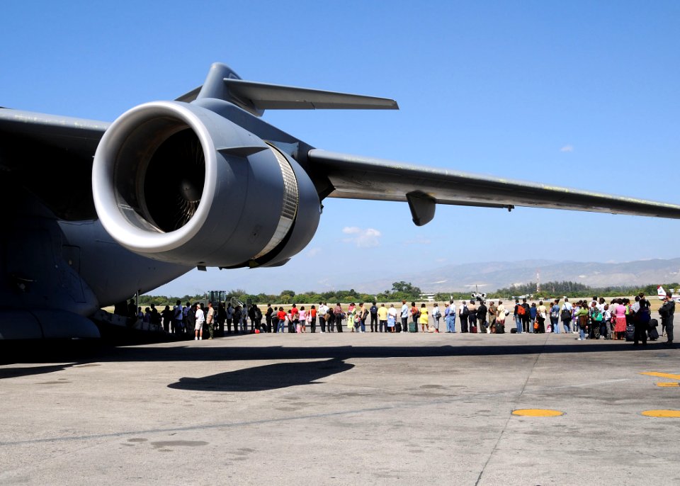US Navy 100123-N-6247V-122 Haitian-Americans prepare to board a U.S. Air Force C-17 Globemaster III transport aircraft destined for the United States