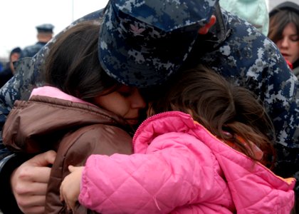 US Navy 100121-N-5087R-033 Fire Controlman 2nd Class Josh Holliday embraces his family