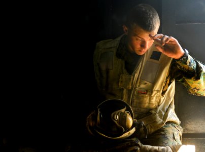 US Navy 100122-N-5345W-002 Lance Cpl. Jack Campbell, assigned to the Sabers of Marine Light Attack Helicopter Squadron (HMLA) 467 takes shelter from the sun during a break between flight operations