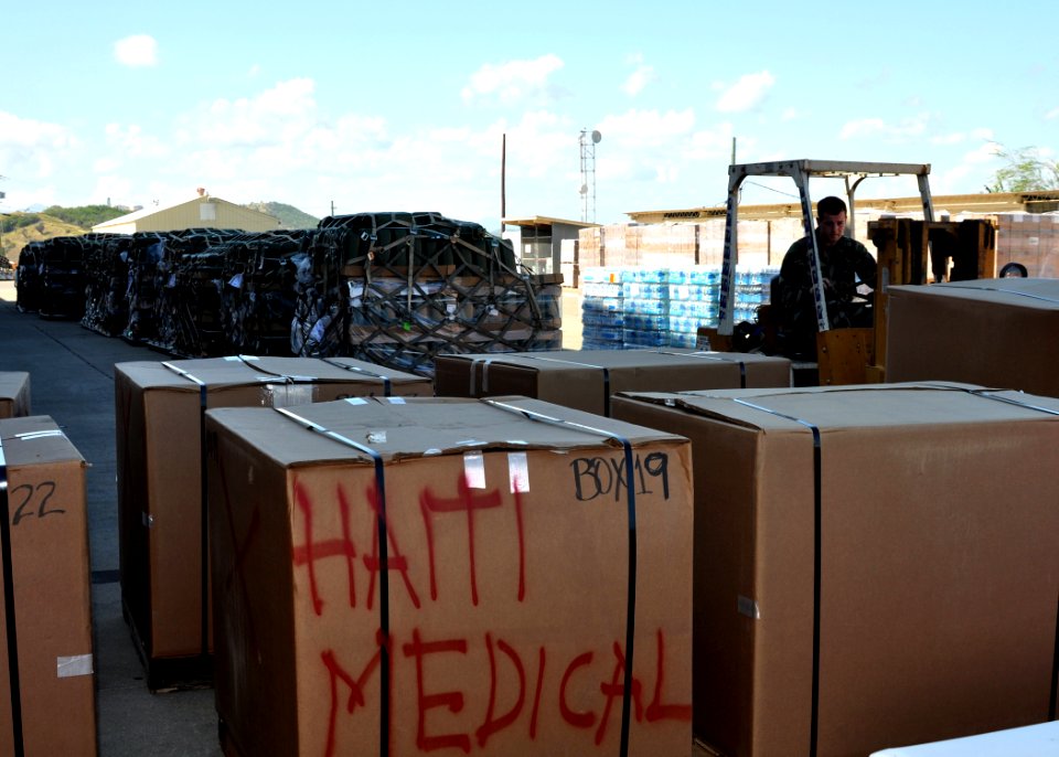 US Navy 100121-N-8241M-007 A Sailor moves pallets of relief supplies at the airfield at Naval Station Guantanamo Bay
