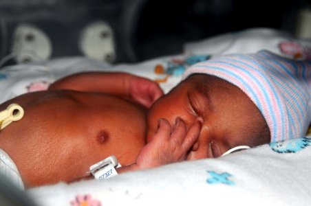 US Navy 100121-N-6410J-485 Medical professionals aboard the Military Sealift Command hospital ship USNS Comfort (T-AH 20) delivered baby Esther at 2-27 p.m. on Jan. 21, 2010. She is the first baby delivered aboard the 1,000-bed