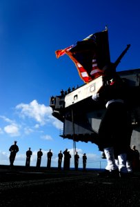 US Navy 100123-N-9928E-032 Sailors parade the colors during a burial at sea ceremony onboard the Nimitz-class aircraft carrier USS John C. Stennis (CVN 74) photo