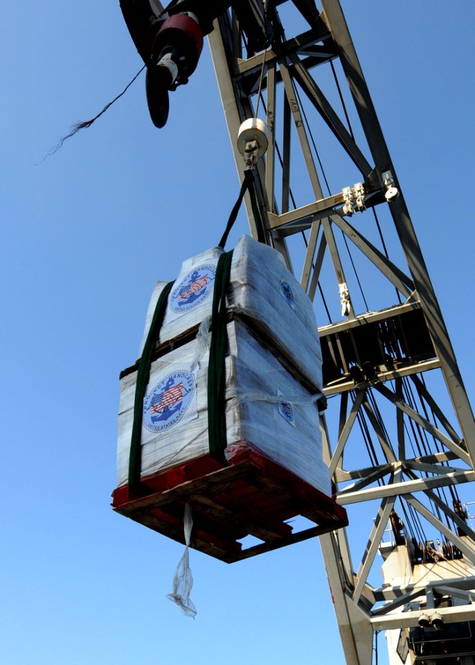 US Navy 100122-N-6676S-002 A pallet of humanitarian aid is craned from USS Gunston Hall (LSD 44) onto a landing craft unit off the coast of Killick