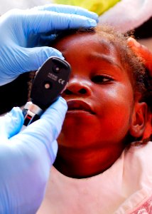 US Navy 100122-N-5244H-048 A 3-year-old Haitian girl is examined at the Hope Estate Medical Clinic in Neply, Haiti photo