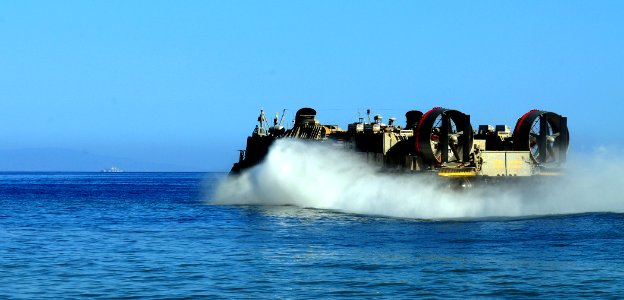 US Navy 100122-N-7508R-009 A landing craft air cushion (LCAC) assigned to Assault Craft Unit (ACU) 4, embarked aboard the amphibious assault ship USS Bataan (LHD 5), departs the Haitian coast after delivering supplies. Bataan