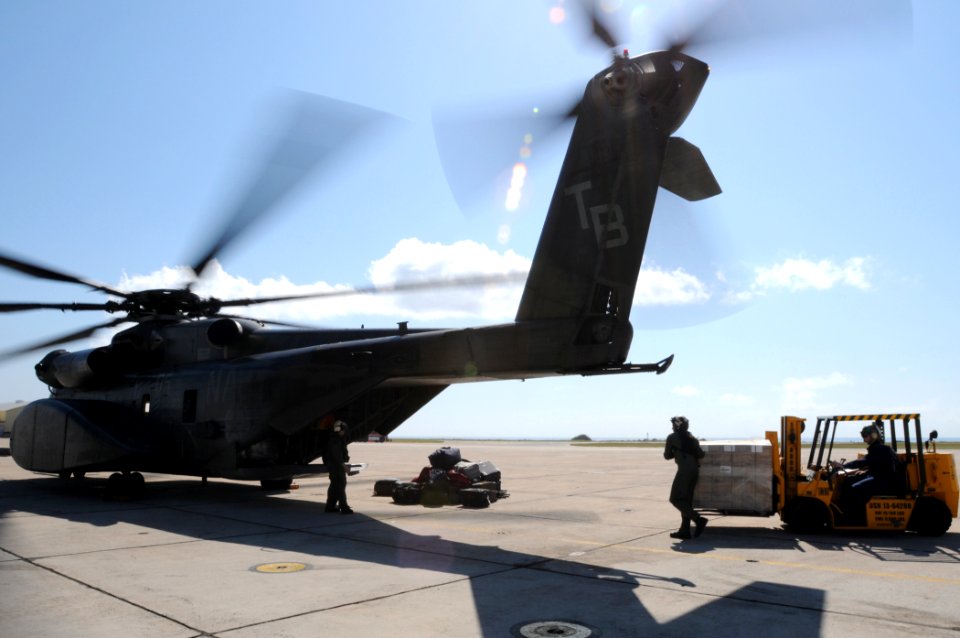 US Navy 100122-N-7456N-057 Navy air crewmen load pallets of meals ready-to-eat onto an MH-53E Sea Dragon helicopter bound for Haiti at the airfield at Naval Station Guantanamo Bay