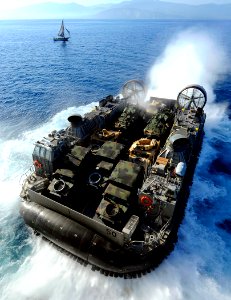 US Navy 100122-N-5345W-003 A landing craft air cushion exits the well deck of USS Bataan (LHD 5) photo