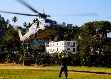 US Navy 100122-N-8655E-033 A MH-60S Sea Hawk helicopter assigned to Helicopter Sea Combat Squadron (HSC) 9 evacuates Haitian civilians from Killick Haitian Coast Guard base to another medical treatment facility