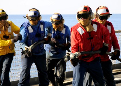 US Navy 100123-N-1082Z-014 Sailors aboard the amphibious dock landing ship USS Ashland (LSD 48) participate in a flight deck firefighting drill