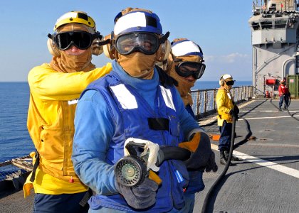 US Navy 100123-N-1082Z-051 Sailors aboard the amphibious dock landing ship USS Ashland (LSD 48) participate in a flight deck firefighting drill