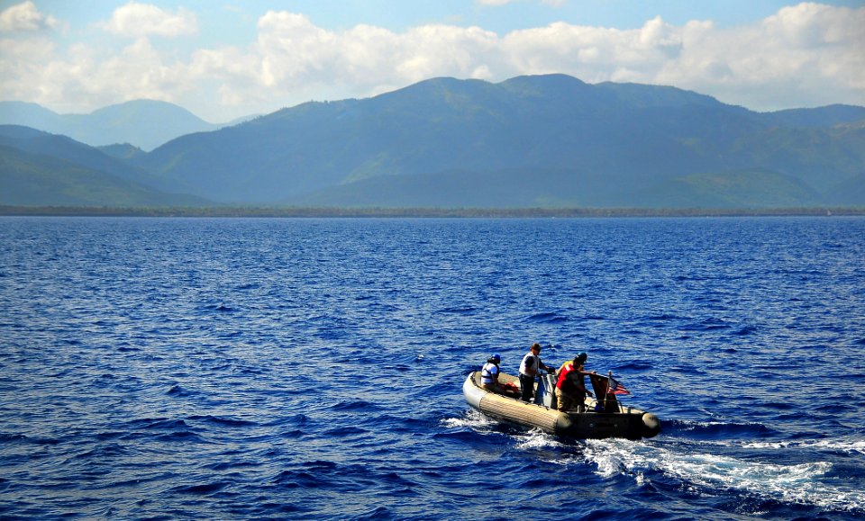US Navy 100123-N-4774B-016 Sailors assigned to the guided-missile cruiser USS Normandy (CG 60) take a rigid-hull inflatable boat to the island of Petit Trou De Nippes