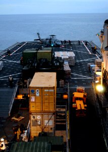 US Navy 100125-N-2000D-015 Sailors aboard the amphibious dock landing ship USS Carter Hall (LSD 50) refuel an MH-60S Sea Hawk helicopter assigned to Helicopter Sea Combat (HSC) 2 off the coast of Haiti