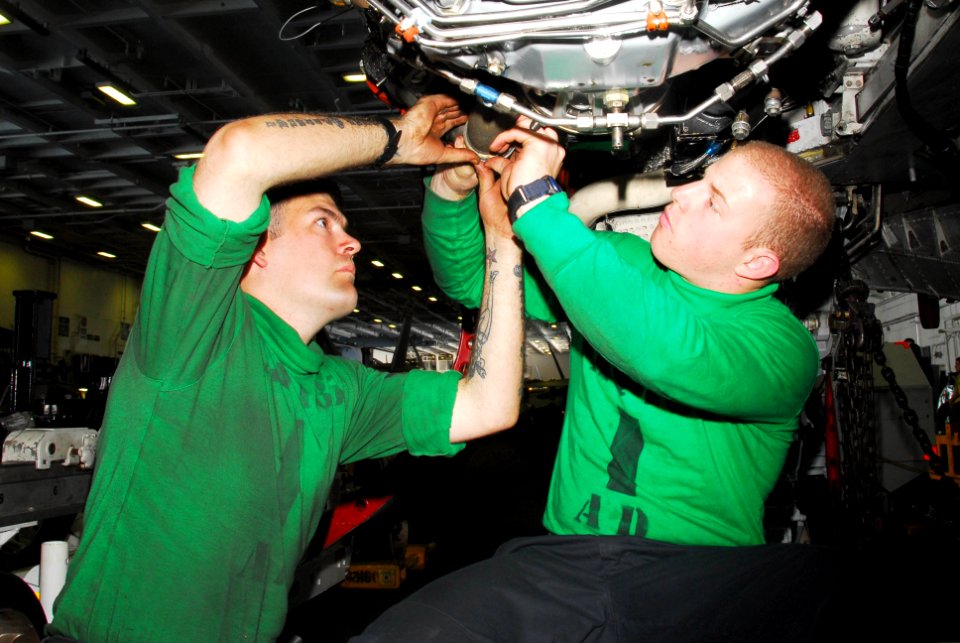 US Navy 100125-N-3327M-033 Aviation Machinist's Mate 3rd Class Bryan Katzenmeyer and Aviation Machinist's Mate Airman Scott Hines perform maintenance on a EA-6B Prowler