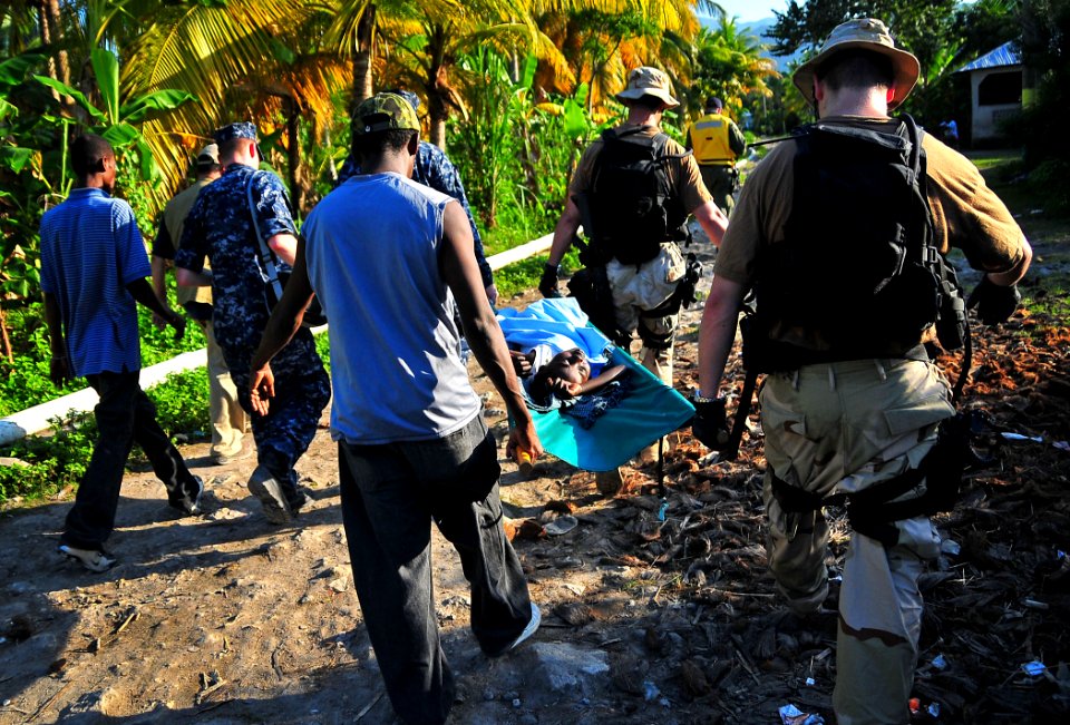 US Navy 100123-N-4774B-865 Sailors assigned to the guided-missile Cruiser USS Normandy (CG 60) transport a Haitian girl for a medical evacuation