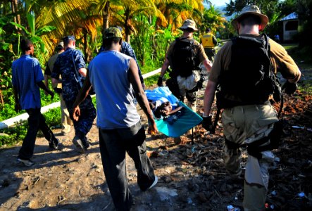 US Navy 100123-N-4774B-865 Sailors assigned to the guided-missile Cruiser USS Normandy (CG 60) transport a Haitian girl for a medical evacuation
