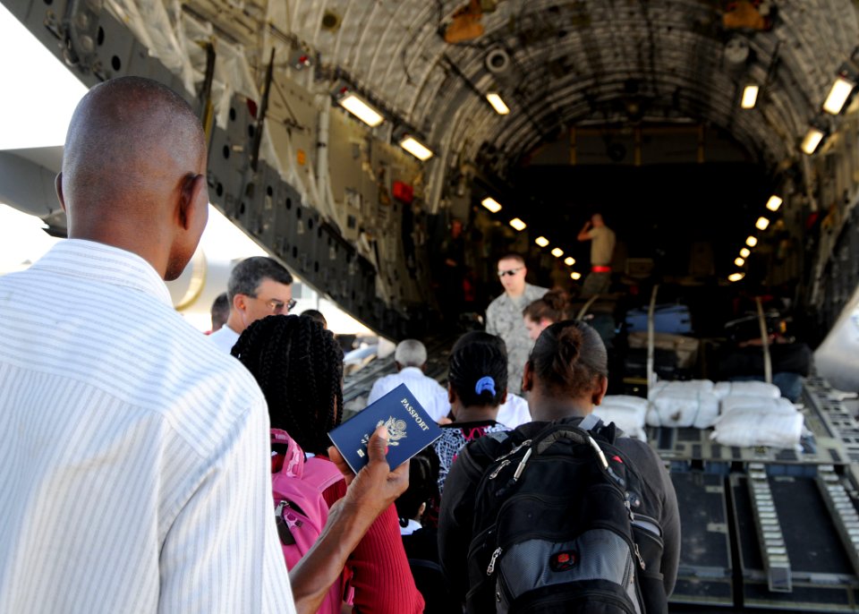 US Navy 100123-N-6247V-135 Haitian-Americans prepare to board a U.S. Air Force C-17 Globemaster III transport aircraft destined for the United States