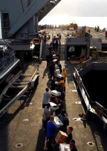 US Navy 100125-N-4971L-403 Sailors and Marines onload stores and relief supplies aboard the amphibious dock landing ship USS Fort McHenry (LSD 43)