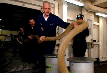 US Navy 100124-N-2475A-056 ailors heave mooring lines as the Nimitz-class aircraft carrier USS John C. Stennis (CVN 74) pulls out of San Diego