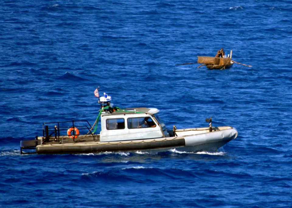 US Navy 100125-N-4971L-049 A security boat patrols the waters surrounding the amphibious dock landing ship USS Fort McHenry (LSD 43) off the coast of Haiti