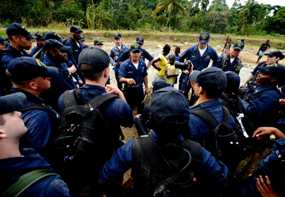 US Navy 100125-N-5345W-429 Lt. Joel Castillo, assigned to the multi-purpose amphibious assault ship USS Bataan (LHD 5) talks to Sailors after they completed the community relief project at the Lifeline Christian Ministries Miss