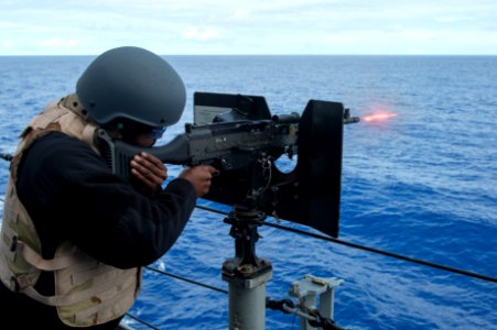 USS Anchorage (LPD-23) sailor firing M240 machine gun during weapons training 140412-N-KL846-078