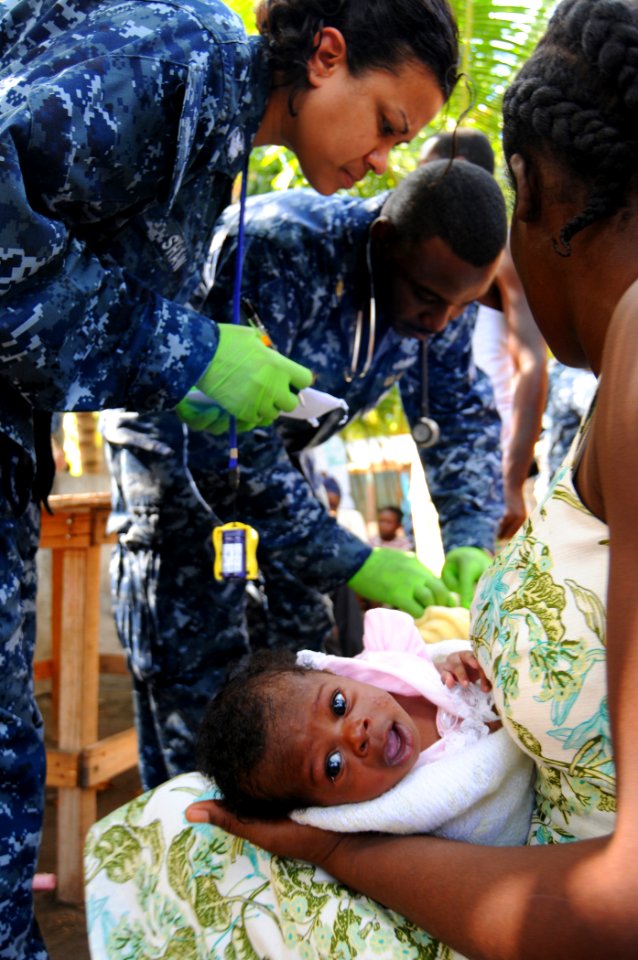 US Navy 100125-N-8878B-206 Culinary Specialist 1st Class Naqueline Shaw assists Chief Hospital Corpsman Carletus Patrick in treating patients