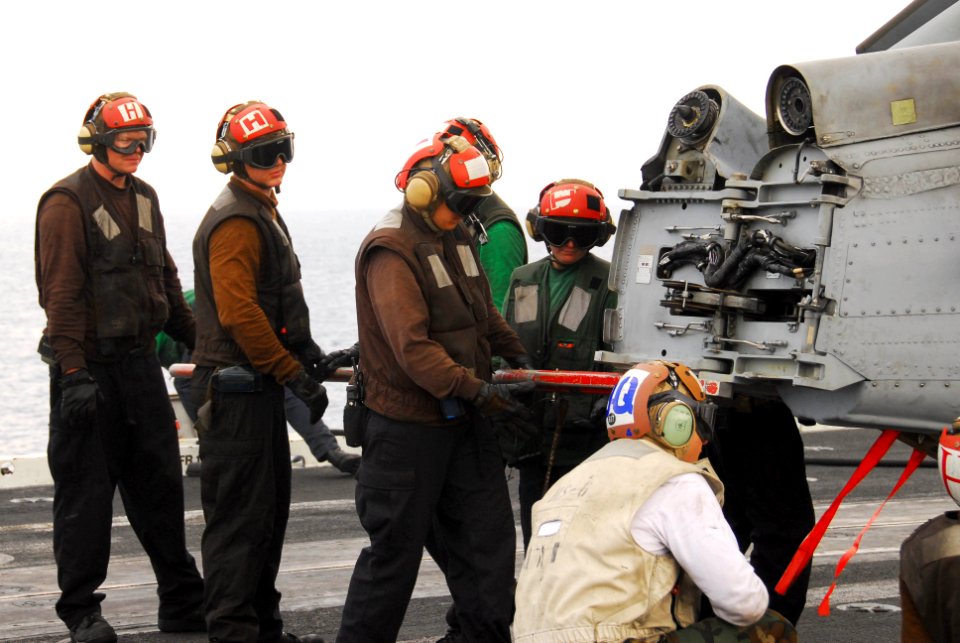 US Navy 100125-N-3327M-090 Sailors assigned to the Indians of Helicopter Anti-Submarine Squadron (HS) 6 prepare to move an HH-60H Sea Hawk from the flight deck of the aircraft carrier USS Nimitz (CVN 68)